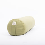 A Maya Shanti Yoga MSY Large Round Buckwheat Bolster in sage green, featuring a small label on one end, sits on a plain white background.