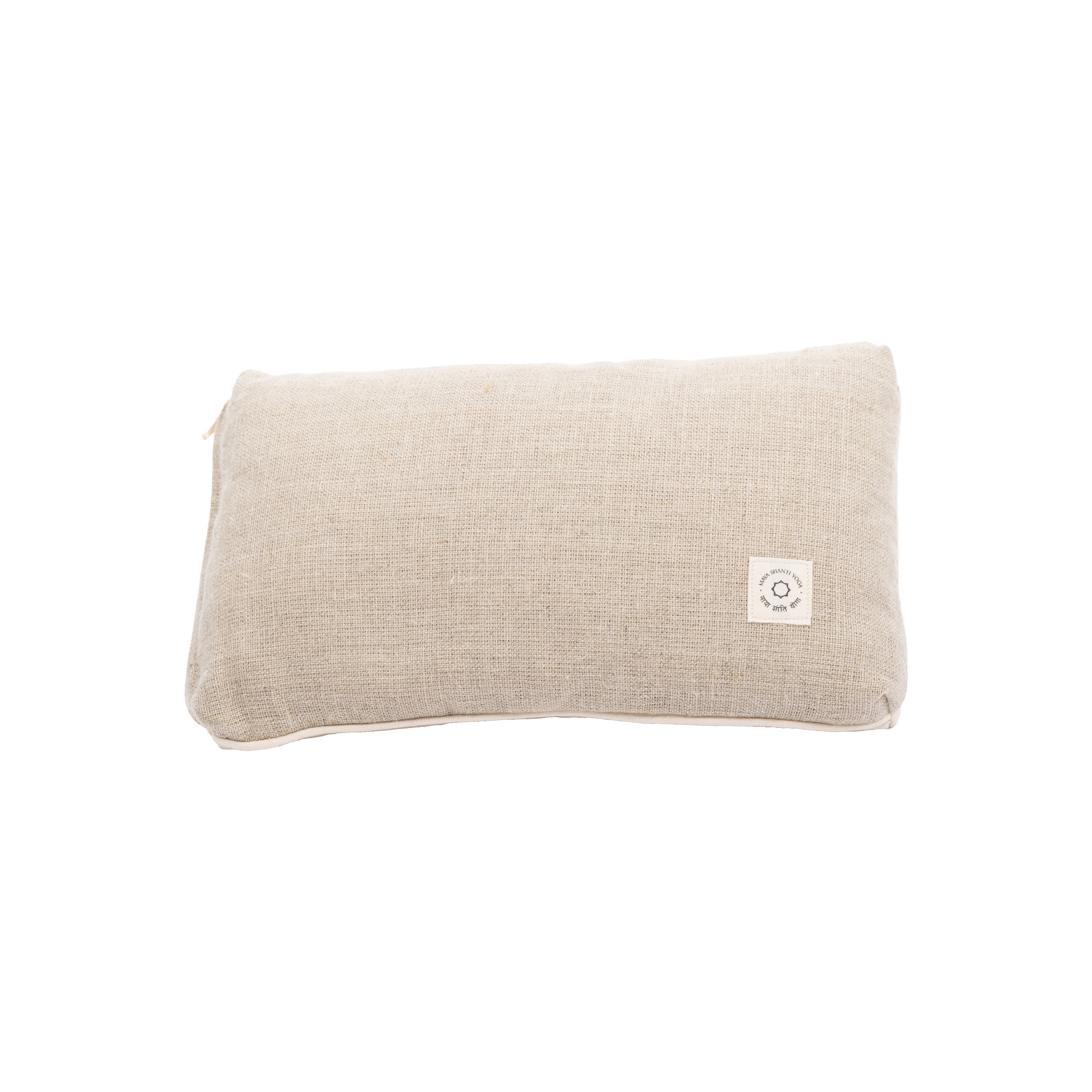 The Maya Shanti Yoga Pillow is a rectangular beige cushion with a textured sustainable hemp cover and a small white square front label, designed for ergonomic support.