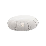 The MSY Zafu - Ice Grey by Maya Shanti Yoga is a round, gray meditation cushion filled with organic buckwheat hulls and has a small label on the side, elegantly resting on a pristine white background.