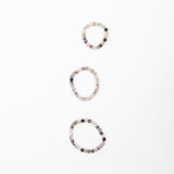Small, medium and large MSY Dragon's Vein Mala Bracelets arranged on a white background from small to large vertically.