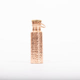 Maya Shanti Yoga Copper Hammered 750ml Water Bottle with wooden lid screwed on, on a white background.