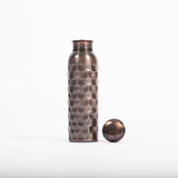 Maya Shanti Yoga Copper Brown Antique 750ml Water Bottle with lid resting next to it on a white background.