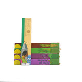 Horizontal stack of vetiver, lemongrass, patchouli and lavender Phool incense stick boxes with eucalyptus sticks resting in front vertically.