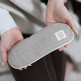 An individual holding a MSY Lavender Eye Pillow - Hemp, Lavender & Linseed from Maya Shanti Yoga while practicing mindfulness.