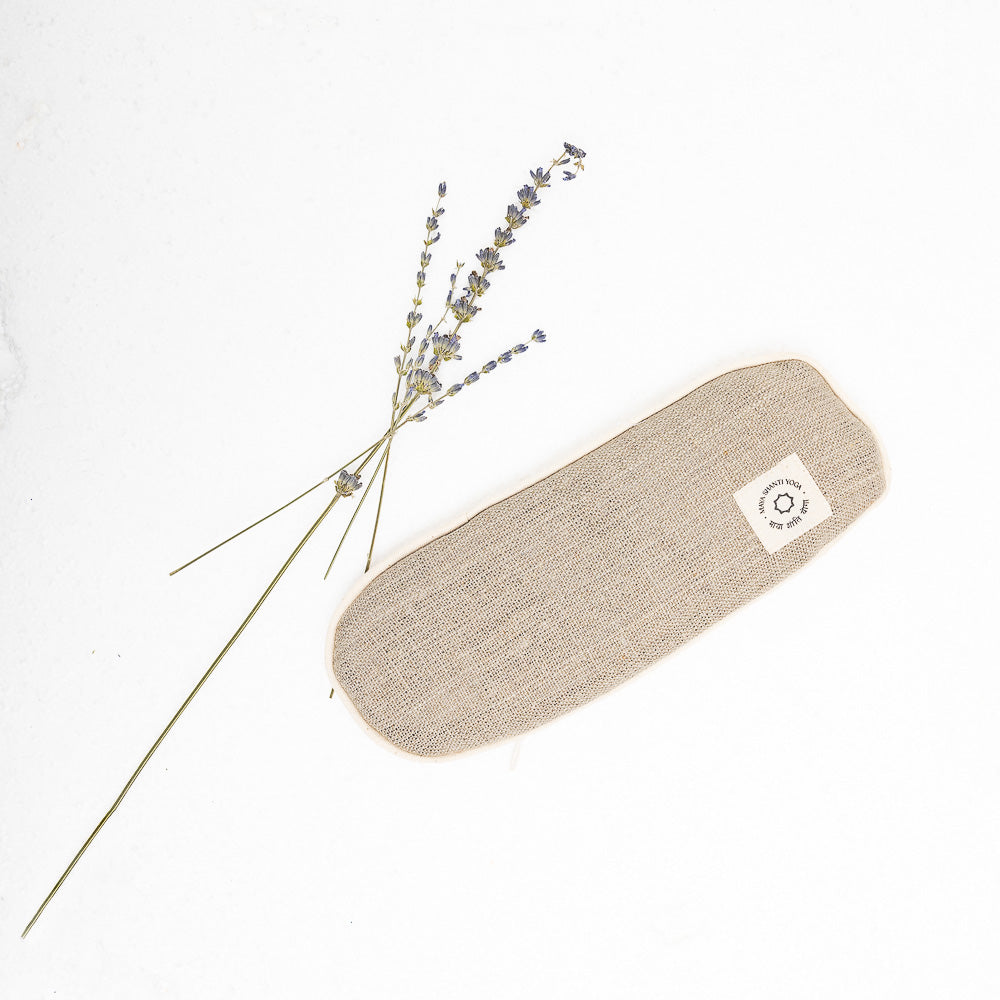 A small MSY Lavender Eye Pillow - Hemp, Lavender & Linseed with a lavender flower on it, perfect for mindfulness practice.