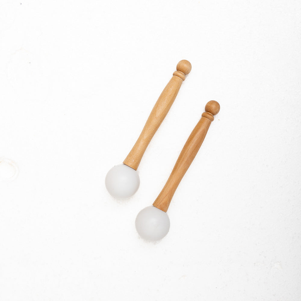 A set of MSY Rubber Mallets For Crystal Bowls by Maya Shanti Yoga on a white surface, inviting mindfulness.