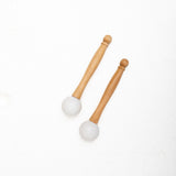 A set of MSY Rubber Mallets For Crystal Bowls by Maya Shanti Yoga on a white surface, inviting mindfulness.