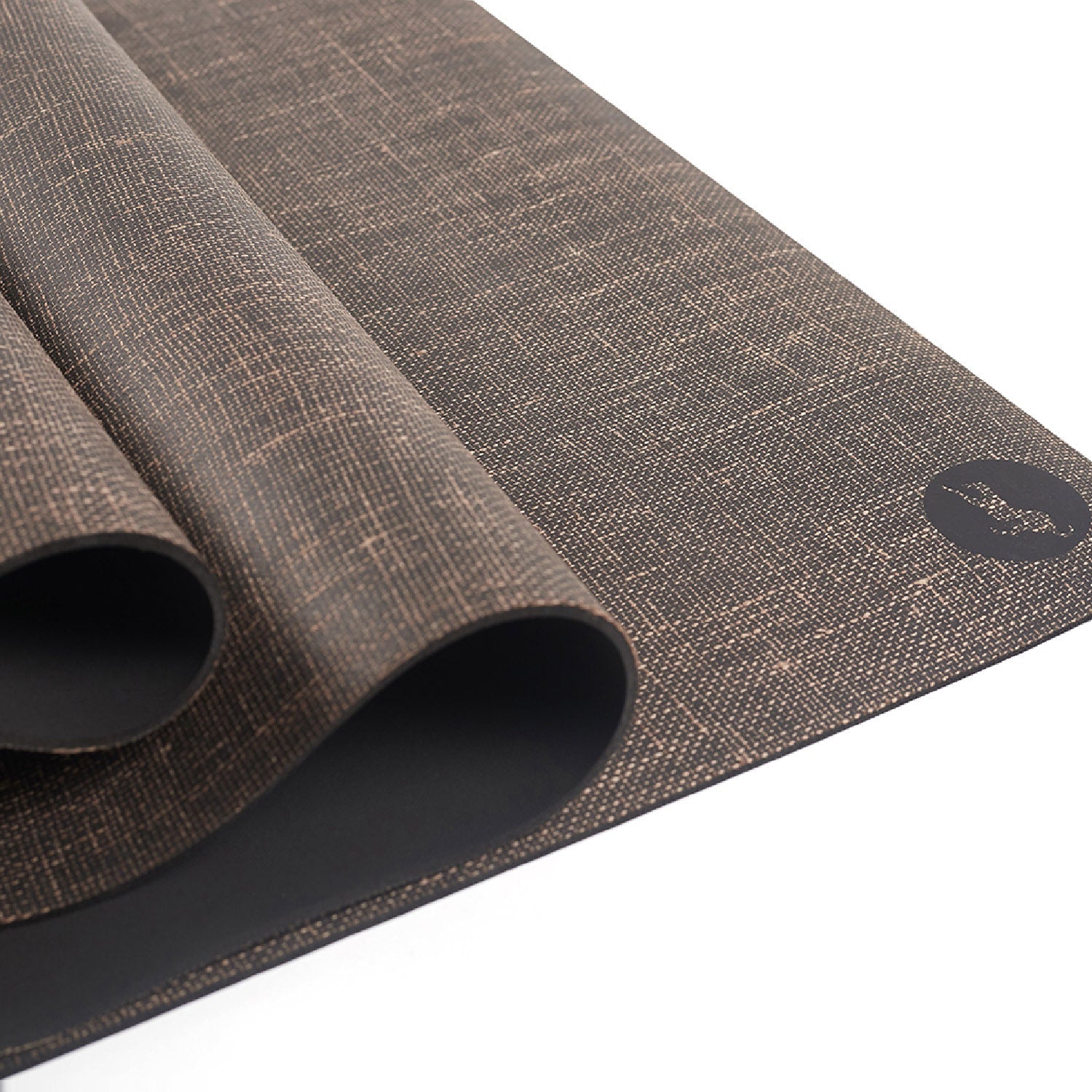 A close-up of the rolled Maya Shanti Yoga Bengal Yoga Mat, an eco-friendly mat made of natural jute and rubber with a textured, non-slip surface and a small round logo in the corner.