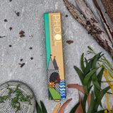 Eucalyptus incense sticks on a textured surface with plants and leaves.