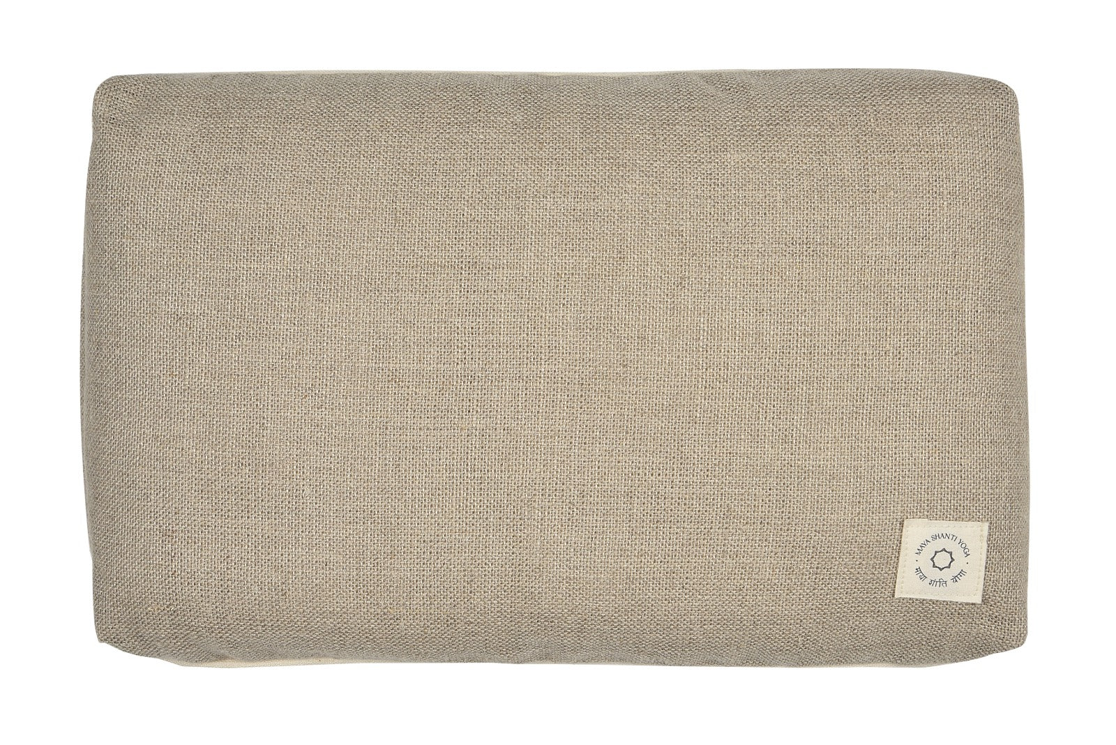 Introducing the Yoga Pillow by Maya Shanti Yoga, a rectangular beige cushion crafted from sustainable hemp with a rough texture and adorned with a visible fabric tag on the bottom right corner.