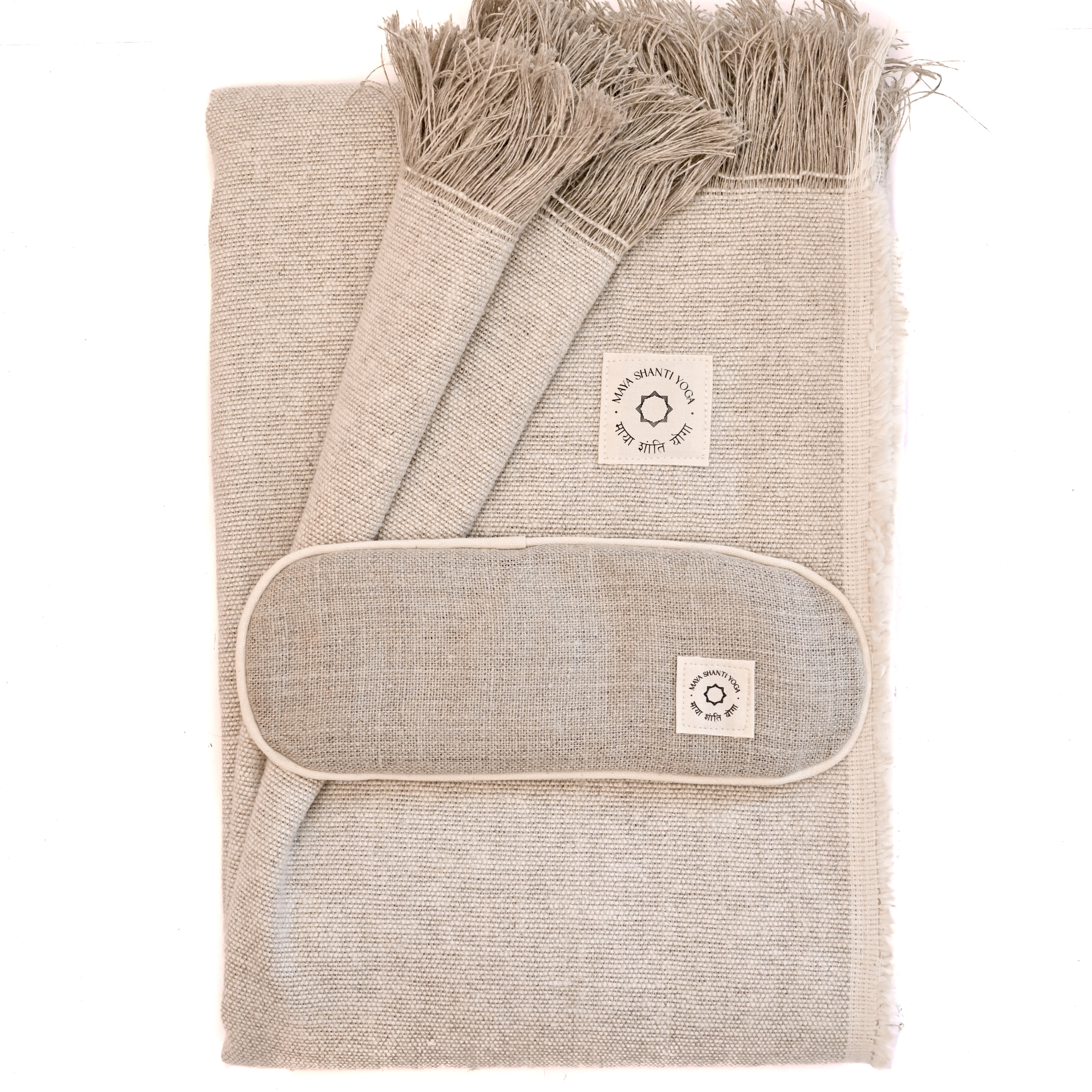 A MSY Relaxation Bundle from Maya Shanti Yoga, including a blanket and eye pillow, stacked on a white background, perfect for meditation.