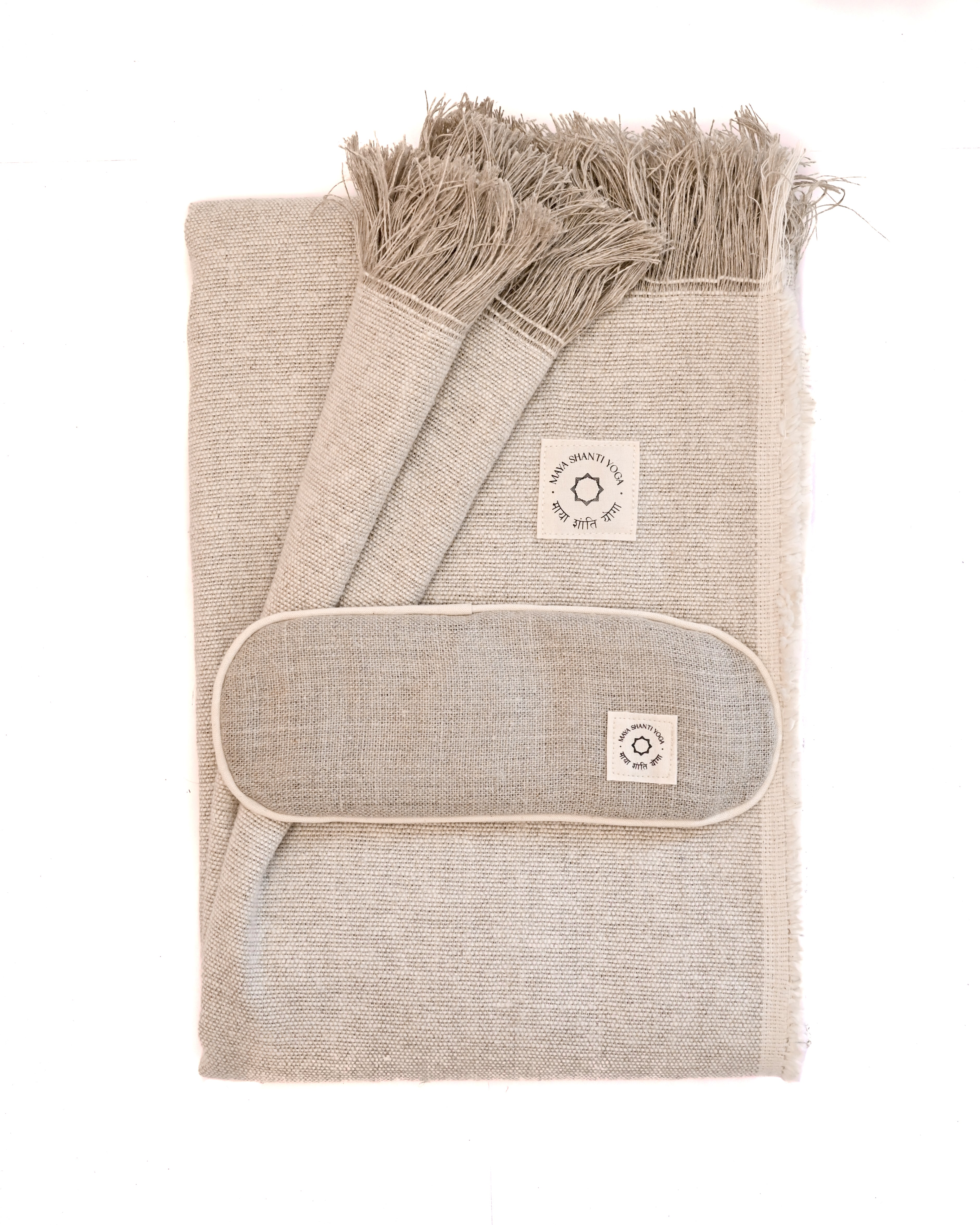 A MSY Relaxation Bundle from Maya Shanti Yoga, including a blanket and eye pillow, stacked on a white background, perfect for meditation.