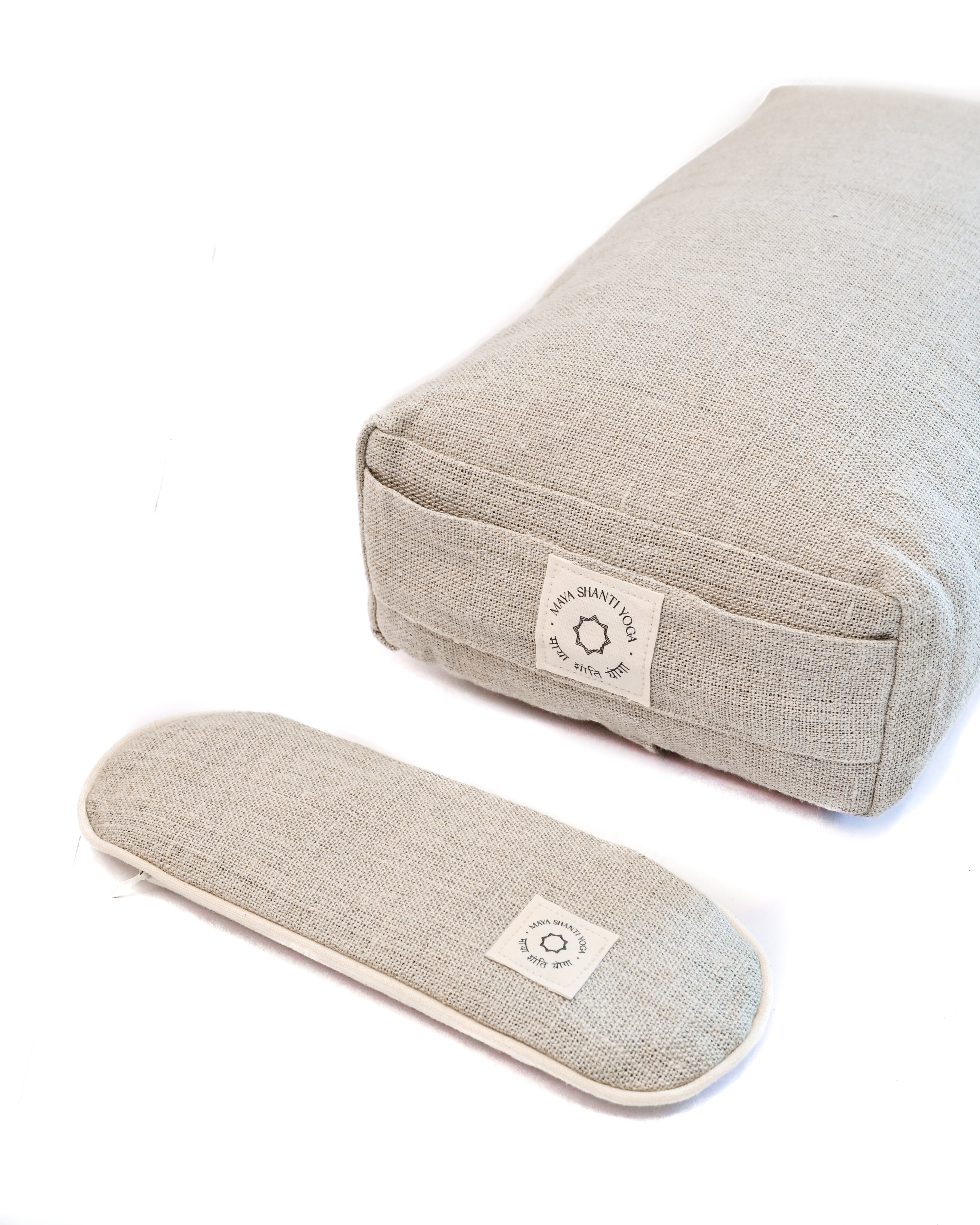 A Maya Shanti Yoga Unwinding Bundle consisting of a Lavender Eye Pillow and a Small Rectangular Bolster, perfect for meditation and relaxation.