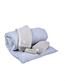 MSY Tranquillity Bundle on a white background including a rolled up Shiatsu meditation bed, grey meditation blanket, small bolster and eye pillow.