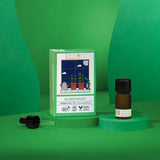 Rosemary essential oil bottle and packaging on a green background