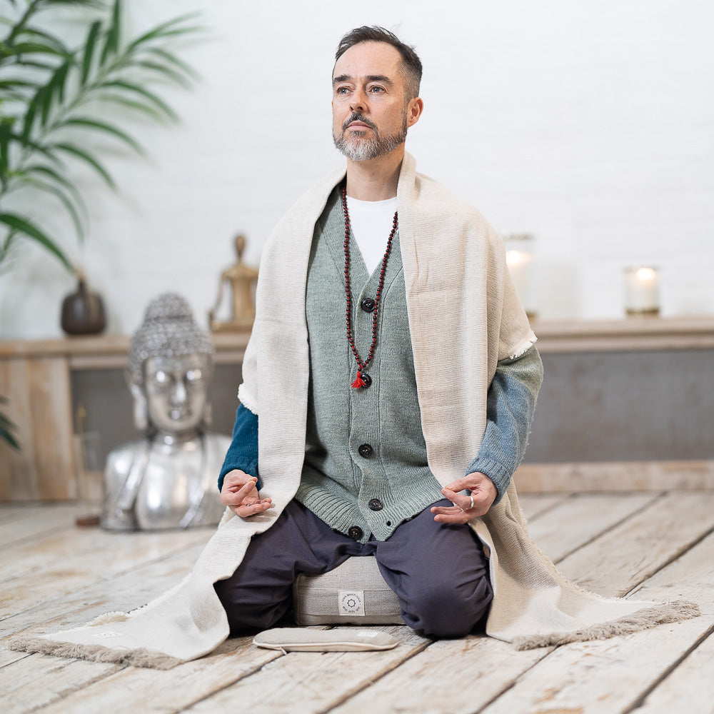 A man practicing mindfulness on a Maya Shanti Yoga MSY Meditation Starter Bundle yoga mat.