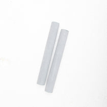 A pair of MSY Suede Mallets For Crystal Bowls from Maya Shanti Yoga, on a white surface, promoting mindfulness and meditation for enhanced wellness.
