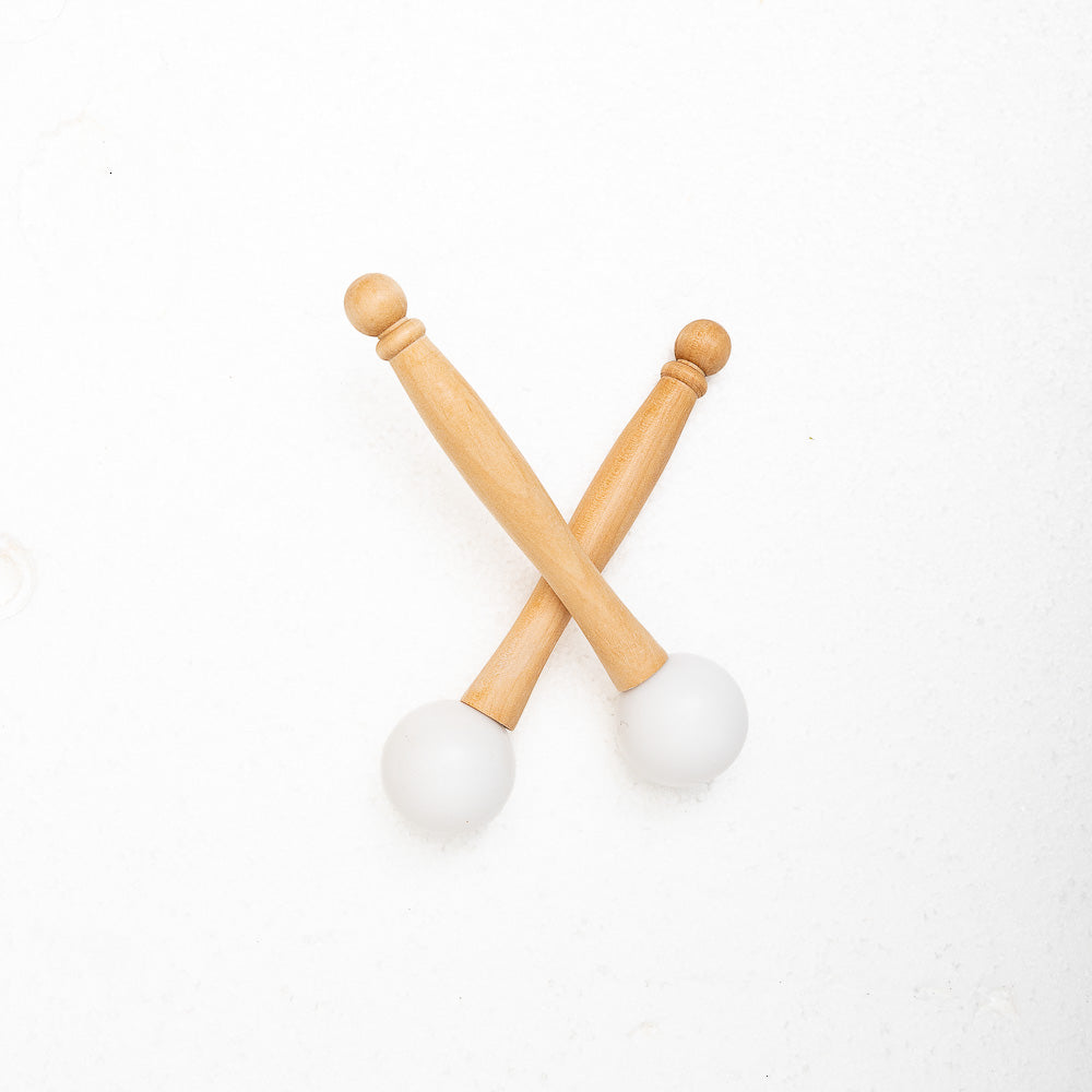 Two Rubber Mallets For Crystal Bowls by Maya Shanti Yoga on a white surface.