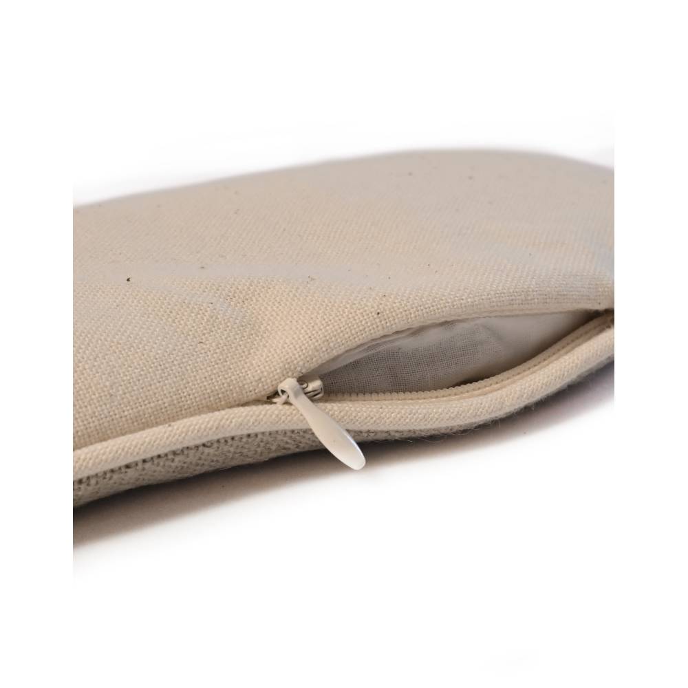 A beige zippered MSY Lavender Eye Pillow - Hemp, Lavender & Linseed pouch, perfect for holding yoga mat or pilates accessories, sitting on a serene white surface, inviting meditation. Brand: Maya Shanti Yoga.