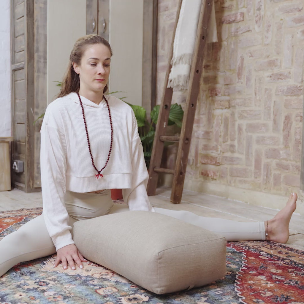 A video of a woman practicing mindfulness while relaxing on a Maya Shanti Yoga  Large Rectangular Bolster - Hemp & Buckwheat.